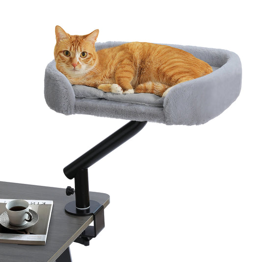 Orange tabby cat resting on a grey plush cat bed attached to a desk clamp mount