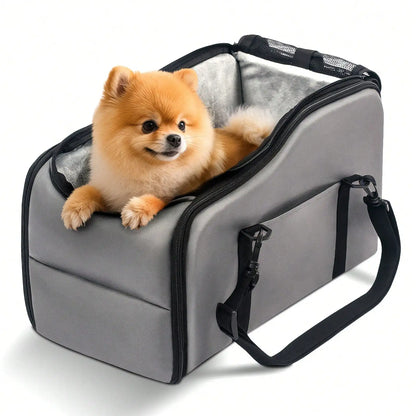Small Pomeranian dog sitting inside a grey pet carrier bag